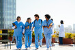 © BONNINSTUDIO/Stocksy - Medical team during conversation on hospital terrace
