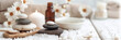 Tranquil spa banner with zen stones, candles, daisies, and bath salt for a serene wellness experience
