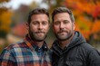 © Good Shot - Identical twins in flannel, outdoors with fall colors, a mirror image.