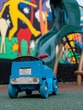 The back of blue vehicle toy for kids sits on the playground