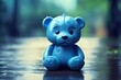 A sad teddy bear sitting alone on the road in rainy background, copy space. Forgotten toy. Blue Monday. Depression concept. Missing children or kidnap kids concept. Child abuse concept.