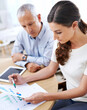 © ArcursJointTeam/peopleimages.com - Meeting, man and woman with paperwork for data analysis, sales review or development with tablet. Planning, strategy and business people with stats, charts and graphs for increase on profit report