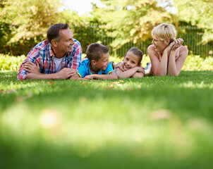 Poster - Garden, park and happy family relax on grass in summer or parents and children together. Mother, father and kids smile in backyard on holiday or vacation in forest, woods or enjoy sunshine in nature