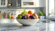 fruit in white bowl with kitchen blurred background 