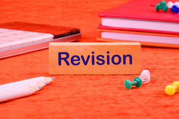 Canvas Print - Revision word on a wooden block next to office supplies