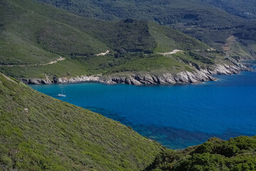 Wall Mural - Corsica, seascape in the cap Corse, a beautiful creek with a boat, transparent water,  in summer
