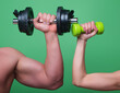 © Volodymyr - Male and female hands with dumbbells close-up. Training muscles. Female and male hand holds dumbbell. Muscular hands, exercises with dumbbells. Strong muscles. Dumbbell isolated. Fitness and Sport.