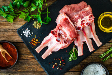 Sticker - Raw veal ribs on cutting board on wooden table
