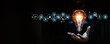 © Jintana - Close up hand choose light bulb or lamp with bright and business icons for human resources or leadership and creativity thinking idea motivation or vision and knowledge learning.