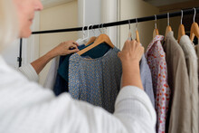 A Senior Woman Choosing Clothes To Wear