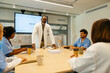© BONNINSTUDIO/Stocksy - Doctor having a presentation to medical colleagues