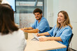© BONNINSTUDIO/Stocksy - Healthcare workers having a meeting at hospital