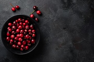 Wall Mural - Ripe cherries arranged in a bowl on a wooden table, ready to be enjoyed as a snack or used in cooking or baking