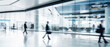 © ND STOCK - Business people walk in a large office lobby against a cityscape background. Motion blur effect, bright business workplace with people in walking in blurred motion in modern office space