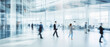 © ND STOCK - Business people walk in a large office lobby against a cityscape background. Motion blur effect, bright business workplace with people in walking in blurred motion in modern office space