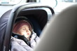 baby girl in the car, warmly dressed, travel