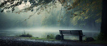 A Pond Surrounded By Fog And Trees With A Bench