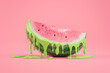 A watermelon slice dripping with green paint on a pink background,  minimal summer concept  in the style of pop art
