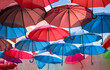 a light spring breeze moves the colored umbrellas high in the sky