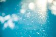 © Austockphoto - Dust on blue water in backyard pool, blue texture background