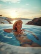 Beautiful young woman enjoy her vacation in santorini, famous place in greece. She is relaxing, smiling and wearing straw hat. Sunset in the background.