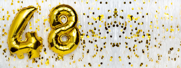 Wall Mural - Golden foil balloon number, figure forty-eight on white with confetti background. 48th birthday card. Anniversary concept. birthday, new year celebration. banner