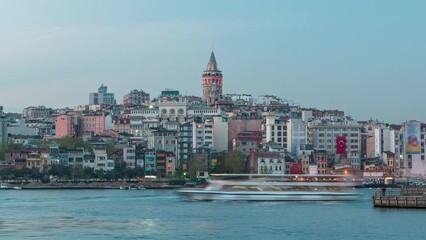 Wall Mural - Evening view over golden horn bay on the galata tower and its neighborhood day to night transition timelapse in Istanbul. Illuminated city skyline reflected on water with ship at spring day