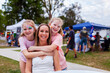 © Austockphoto - Portrait of Aussie mum and two daughters together at summer time event