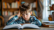 © safu designe - Concentrated child doing his homework at home. The boy struggles to read a book. Education, school, learning disability, reading difficulties, dyslexia concept
