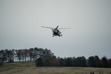 Wall Mural - British army AgustaWestland AW159 Wildcat AH1 helicopter flying low over open countryside