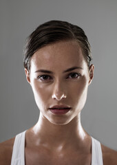 Canvas Print - Woman, serious face and confident for fitness, strong and determined with sweat from workout on grey background. Headshot, portrait and athlete for sports, exercise with pride and power in studio