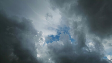 Wall Mural - Storm clouds and hole with blue sky