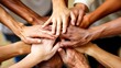 © Radomir Jovanovic - A powerful image of diverse hands coming together in unity and teamwork on a neutral background