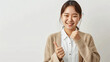 Happy smiling young Asian female teacher in a cardigan and white shirt