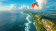 Paragliding in the sky. Paraglider tandem flying over the sea with blue water and mountains in bright sunny day. Aerial view of paraglider