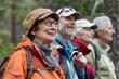 © Татьяна Евдокимова - Group of joyful elderly friends enjoying a hike in the woods, with one holding a camera