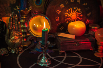 Wall Mural - Table with candles and esoteric stuff. Herbs and wax around. Rite concept 