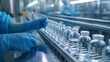 Hand in sanitary gloves checking pharmaceutical glass bottles on production line.