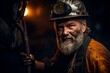 © Maria - Miner in a helmet and work clothes, with a beard and a dirty face in a mine, close-up