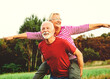 © Lumos sp - woman man outdoor senior couple happy lifestyle retirement together smiling love piggyback active mature