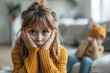 Young stressed girl child with sibling in blurry background