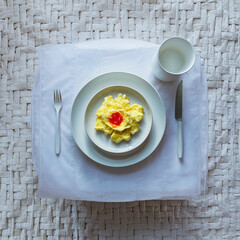 Sticker - scrambled eggs in a white plate on the table