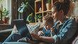 © Studio Nova - Woman is sitting on a couch, holding a toddler on her lap while working on a laptop in a cozy home environment.