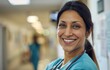 Close-up of a South Asian nurse's smile, comforting and warm, in a hospital corridor