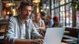 Fototapeta  - Man working on laptop in cafe, blurr people in background
