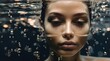 Woman face submerged in water with bubbles or Woman head half submerged under water. Sunset coming through water. Creative underwater shooting perfect for advertisement