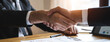 © Pormezz - client and banker shaking hands  on the meeting table after business investment budget done