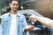 Buy second-hand auto or rent a car concept, Close-up hand of used car agent giving an auto key to client.