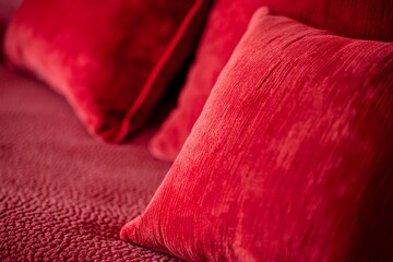 pillows on red background closeup, pillows closeup, pillows in the sofa closeup, colorful pillows closeup