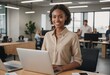 © natakot - African American woman using laptop in modern office. Engaged and proactive professional.